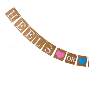 Detail of kraft paper HEELS OR WHEELS gender reveal banner with blue and pink hearts