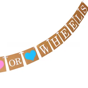 Detail of kraft paper banner with OR WHEELS text and blue heart for gender reveal party