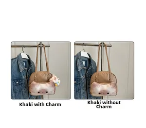 Detail view of khaki cat print handbag comparing styles with and without plush pendant