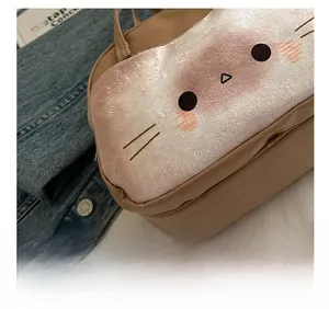 Detail showing the neat stitching and soft plush material of the cat shaped handbag