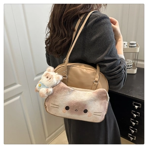 Detail of beige shoulder bag with pink plush cat face pocket and cute kitty pendant