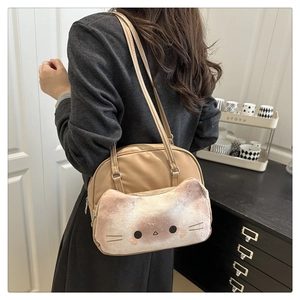 Detail of cute cat plush pocket and embroidered face on beige canvas shoulder bag