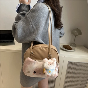 Chic khaki cat-patterned canvas tote bag with cute bear charm shown on shoulder