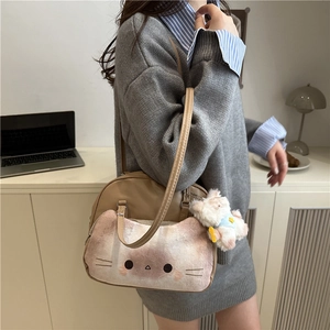 Cute cat-themed beige shoulder bag with pink plush face and a small dog charm