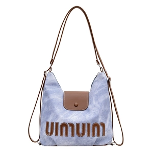 Blue denim and brown leather dual-strap backpack with stylish vintage wash finish