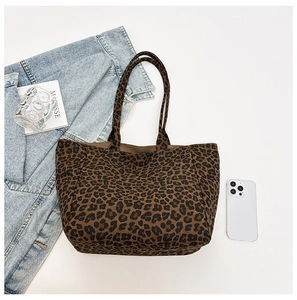 Detail view of leopard print tote bag with thick fabric texture and spacious shoulder straps