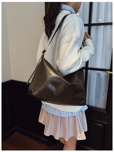 Side view of dark coffee faux leather tote bag showing large capacity and soft texture