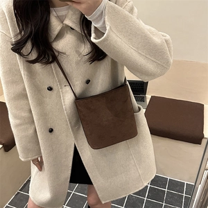 Minimalist dark brown suede bucket bag with crossbody strap for elegant winter fashion