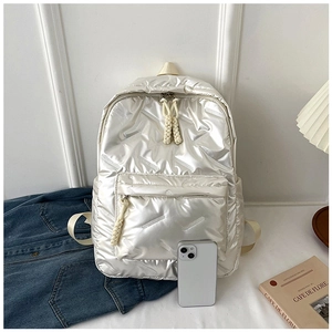 Quilted pearl white backpack showing glossy texture and size reference with a smartphone