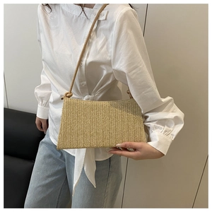Close-up of beige woven shoulder bag featuring premium herringbone weave texture