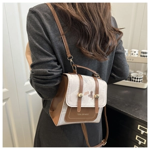 Detailed view of vintage canvas and leather crossbody bag with cat print on a model