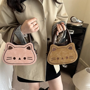 Cute cat-shaped suede handbag for women in pink and tan with creative cat face embroidery