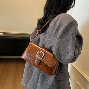Chic brown oil wax leather shoulder bag with vintage silver buckle in high-end minimalist style