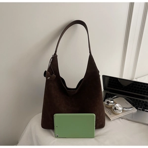 Detail of dark brown hobo shoulder bag with matte finish and adjustable side drawstring