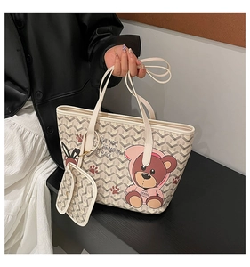 Detail of cute bear print and geometric pattern on beige shoulder tote bag set