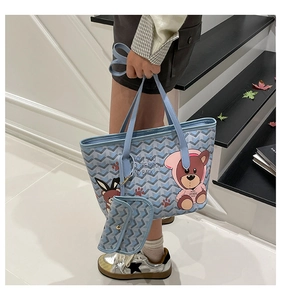 Detail of blue tote bag with cartoon bear print and stylish sub-bag for winter fashion