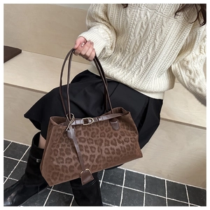 Close-up of leopard print shoulder bag with elegant brown texture and metal buckle