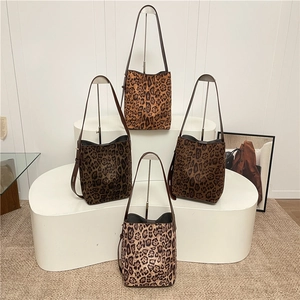 Fashionable leopard print bucket bags in various patterns with adjustable brown straps