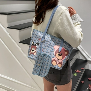 Light blue tote bag set with cute bear print and chevron texture worn by a model