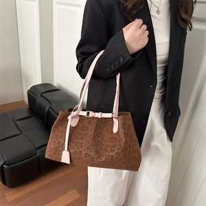 Retro leopard print tote bag with pink straps shown as a shoulder bag on a model