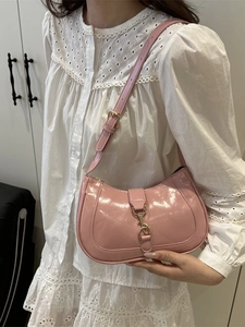 Sac hobo en cuir verni rose avec fermoir doré porté sur l'épaule pour femme