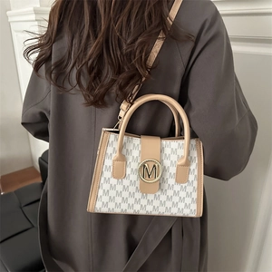 Chic vintage shoulder bag with M-pattern print and khaki leather straps for women