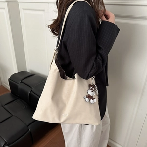 Chic beige Hobo shoulder bag with large capacity and cute puppy charm accessory
