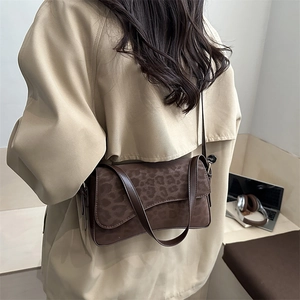 Chic leopard print crossbody bag with brown suede texture and long leather strap