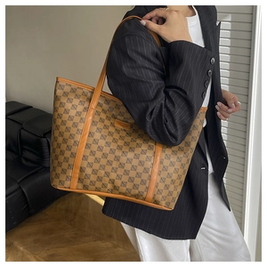 Detailed view of the large capacity printed tote bag with leather straps and geometric pattern