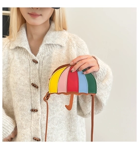 Close-up of a colorful umbrella-shaped crossbody bag with multi-color leather panels