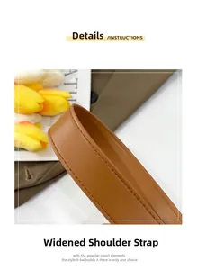Detail of wide brown leather shoulder strap with premium reinforced stitching craftsmanship