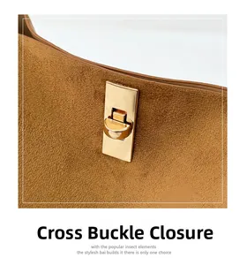 Detail of caramel suede bag featuring a gold rectangular twist lock with cross closure