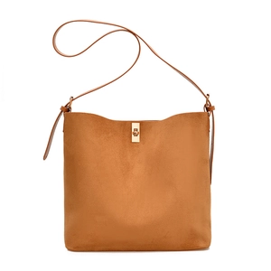 Minimalist caramel suede shoulder bag with golden twist lock on white background