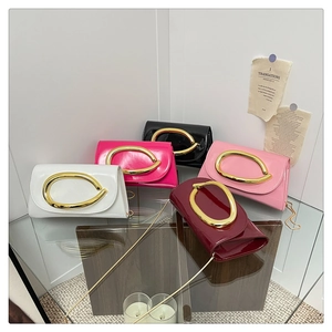 Five glossy patent leather crossbody bags with large gold buckles and chain straps