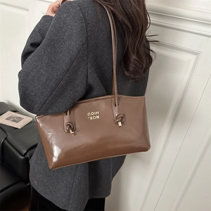 Dark brown patent leather shoulder bag with gold logo and knotted strap detail