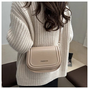 Detail of apricot flap crossbody bag with fashion print and elegant leather texture