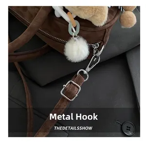 Detailed close-up of premium silver hardware hooks and adjustable straps on leopard bag