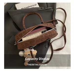 Macro detail of spacious interior in leopard print suede baguette bag with plush bear