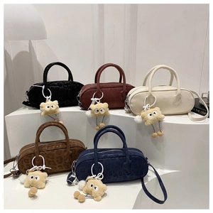 Five barrel bags in various colors with leopard texture and yellow plush doll charms