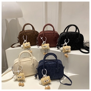 Detailed view of fashionable square handbags in five colors with cute plush charms