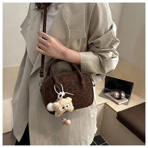 Close-up of leopard pattern crossbody bag with cute plush star charm detail