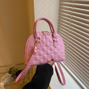 Pink shell handbag with checkered embossing and golden hardware in a hand-held style