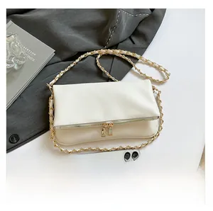 White pebbled leather shoulder bag with gold dual zipper detail and chain strap