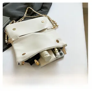 Top view of white lychee leather chain bag showing spacious interior with cosmetics