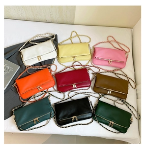 Detail showing nine colors of lychee grain leather crossbody bags with double zippers