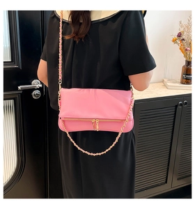 Pink faux leather shoulder bag featuring decorative gold double zippers and metal chain strap