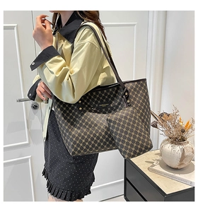 Detailed view of the dark brown patterned tote bag and mini pouch with golden logo plate