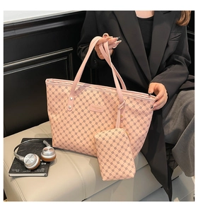 Pink monogram tote bag set with matching pouch shown in a stylish urban office setting
