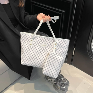 White monogram tote bag with matching pouch and dark geometric patterns on PU canvas