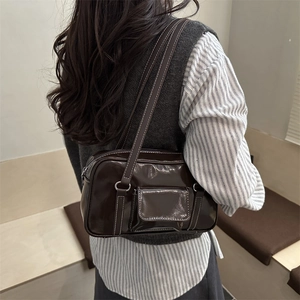Brown gloss leather shoulder bag with white contrast stitching and silver hardware detail